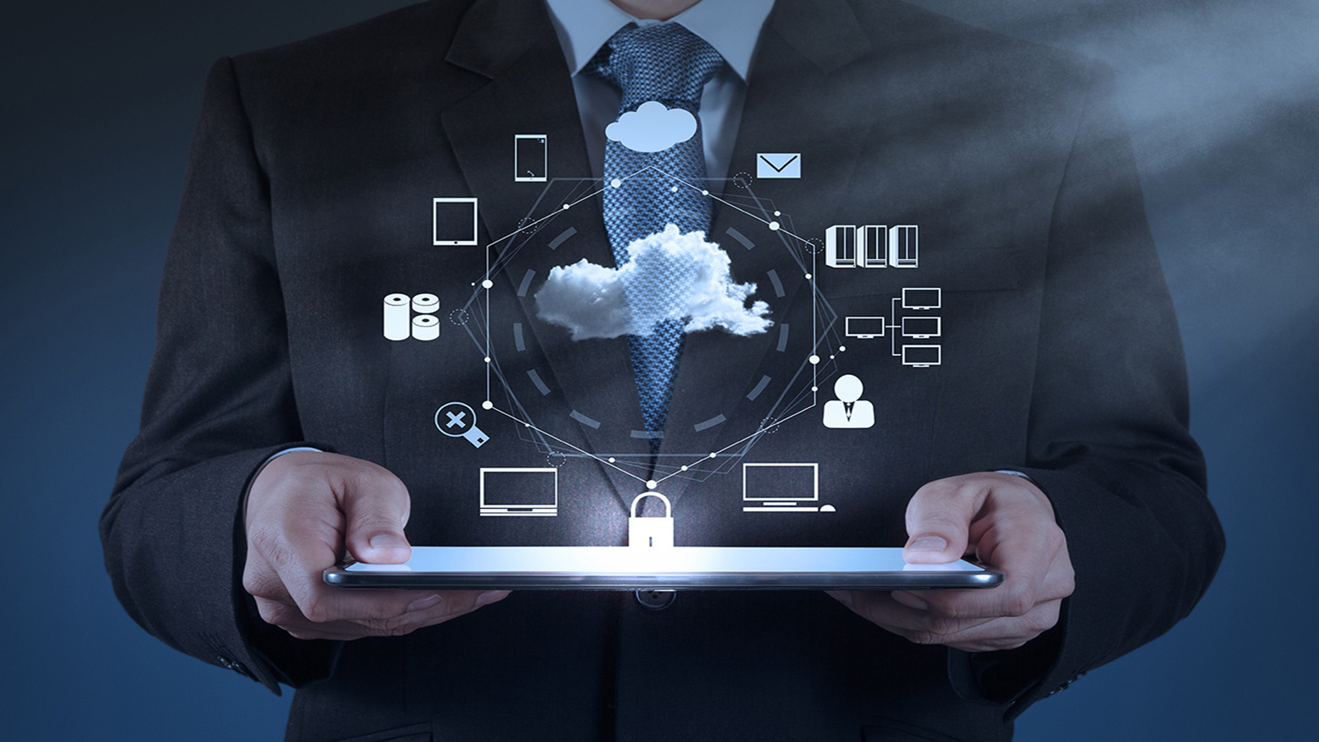 image of man holding a tablet with cloud above it giving the appearance of a networked infrastructure